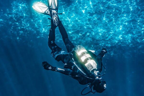 person diving on blue water